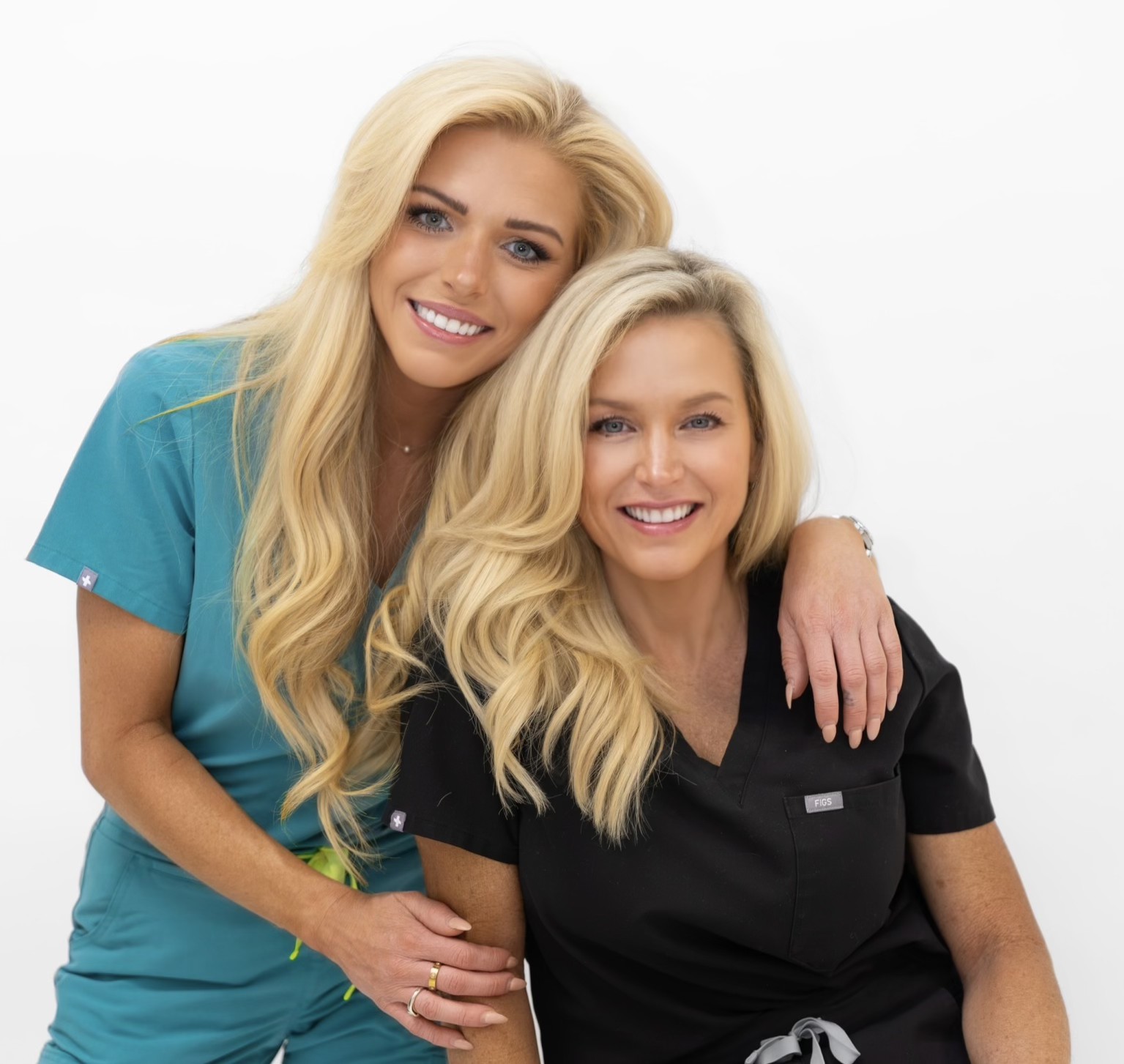 LUMA+ founders in scrubs sharing a hug